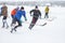 Group active people playing hokey on a frozen river Dnipro in Ukraine