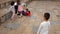 Group of active schoolchildren playing football together on the street