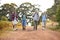 Group Of Active Senior Friends Enjoying Hiking Through Countryside Walking Along Track Together