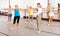 Group of active women practicing energetic dance in a studio