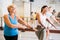 Group of active women practicing energetic dance in a studio