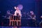 Group of actresses drum taiko drums on the stage