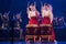 Group of actresses in traditional kimono and fox masks drum taiko drums on the stage