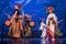 Group of actresses in traditional kimono and hats dancing with taiko drummers on the stage