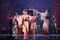 Group of actresses in traditional white and red kimono and fox masks dance and drum a big taiko