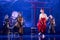 Group of actresses in traditional white and red kimono and fox masks dance on the stage