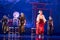 Group of actresses in traditional white and red kimono and fox masks dance on the stage