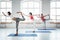 Group of adult healthy woman practice yoga poses together indoor class early morning. Healthy lifestyle concept