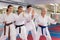 Group of adult people practicing martial arts in gym