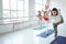 Group of adult women doing yoga exercises together in fitness class. Active people practice yoga poses on mat