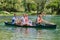 Group adventurous explorer friends are canoeing in a wild river