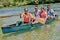 Group adventurous explorer friends are canoeing in a wild river