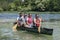 Group adventurous explorer friends are canoeing in a wild river