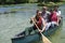 Group adventurous explorer friends are canoeing in a wild river