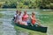 Group adventurous explorer friends are canoeing in a wild river