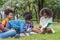 Group of African American children practice drawing in a book and sitting in the park. Education outdoor concept