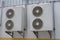 Group of air conditioner units on wall outside building