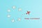 Group of airplanes flying in a circle, red plane thinks different and takes the opposite direction, against the stream symbolic
