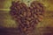 Group almond nuts forming a heart-shape on wooden table. Concept