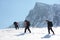 Group of alpinists trekking on a snowy mountain path in a wonderful sunny day.