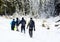 Group of alpinists trekking on a snowy mountain path in a wonderful sunny day.