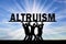 Group of altruistic people hold the word altruism over them