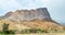 Group of ancient stone beehive tombs with Jebel Misht mountain in the background, archaeological site near al-Ayn, sultanate Oman