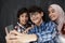 Group of arab teens taking selfie photo on smart phone