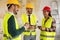 Group of architects talking on coffee break at construction site