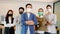 Group of Asian business men leader standing wearing mask smile cross arm confidence with Business team at Co-Working space