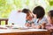 Group of asian children drawing and painting with crayon