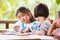 Group of asian children drawing and painting with crayon