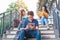 Group of Asian college student reading and reviewing by textbook and laptop at stair at university. Technology and Education