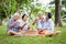 A group of Asian elders are sitting, relaxing and preparing snacks in the shady garden. Watch them happy