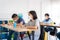 Group of Asian elementary school students wearing hygienic mask to prevent the outbreak of Covid 19 in classroom while back to