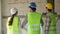 Group of Asian engineer or Young Female Architect put on a helmet for safety and talk with a contractor on a construction building