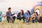 Group of Asian friendship clinking drinking bottle glass for celebrating in private party with mountain and lake view background.