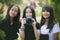 Group of asian teenager relaxing in garden with dslr camera in hand