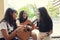 Group of asian teenager standing outdoor plying spanish guitar and dancing with happiness emotion