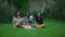 a group of Asian teenagers having tea with their friends in a green park