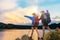 Group asian young women of hikers walking with backpack on a mountain at sunset. Traveler going camping.