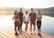 A group of athletes stands on the background of a lake in a city park.