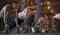 Group of Athletic Men Training Push Ups in Gym