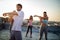 Group of athletic young people, friends in sportswear doing exercises. Sport outdoors