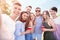 Group of attractive young people taking selfie outdoors