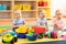 Group of babies is playing on floor in nursery. Children in the day care center. Fun in the children`s playroom