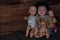 A group of baby dolls sitting in an old wooden house