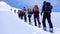 Group of backcountry skiers climbing a mountain in the Swiss Alps