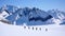 Group of backcountry skiers crossing a glacier on their way to a high summit in the Alps