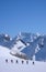 Group of backcountry skiers crossing a glacier on their way to a high summit in the Alps